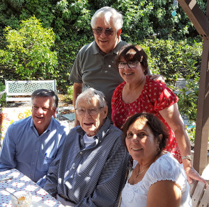 The oldest living elected person in Culver City, James Gibson, seated, second from left, enjoys company and a barbecue meal with Mayor Jim Clarke, seated at left, Marla Wolkowitz (standing) and hosts Madeline and Paul Ehrlich.  