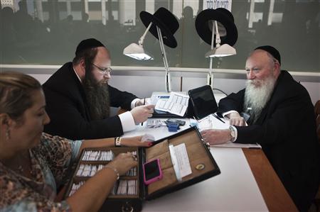Ultra-Orthodox Jews work in the trading room of Israel's diamond exchange in Ramat Gan near Tel Aviv